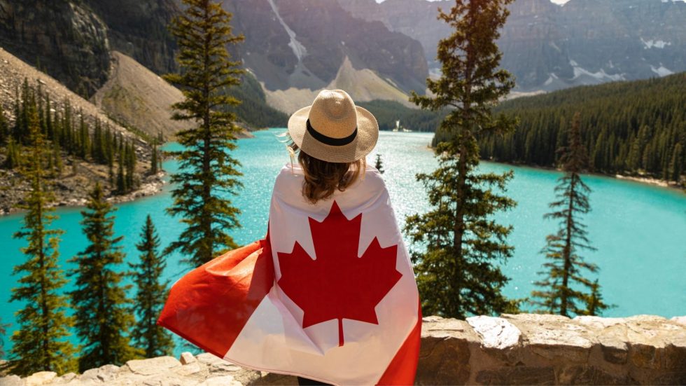 woman in front of lake with canadian flag