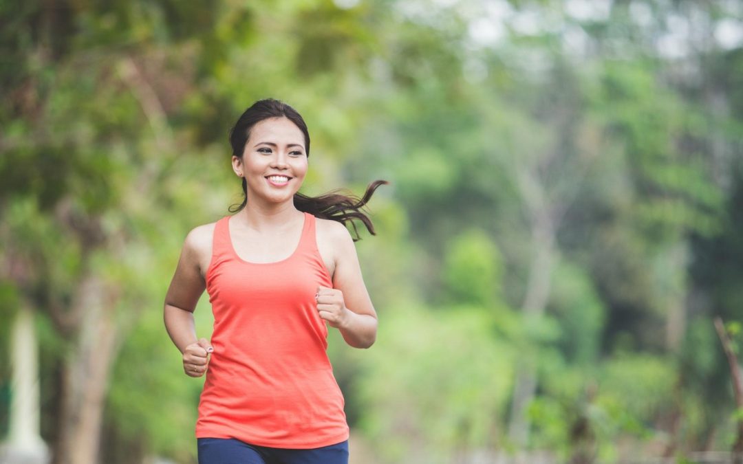 woman in orange top jogging
