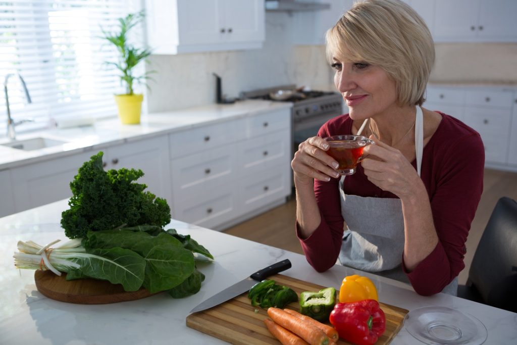 Healthy woman in menopause eating vegetables instead of sugary foods