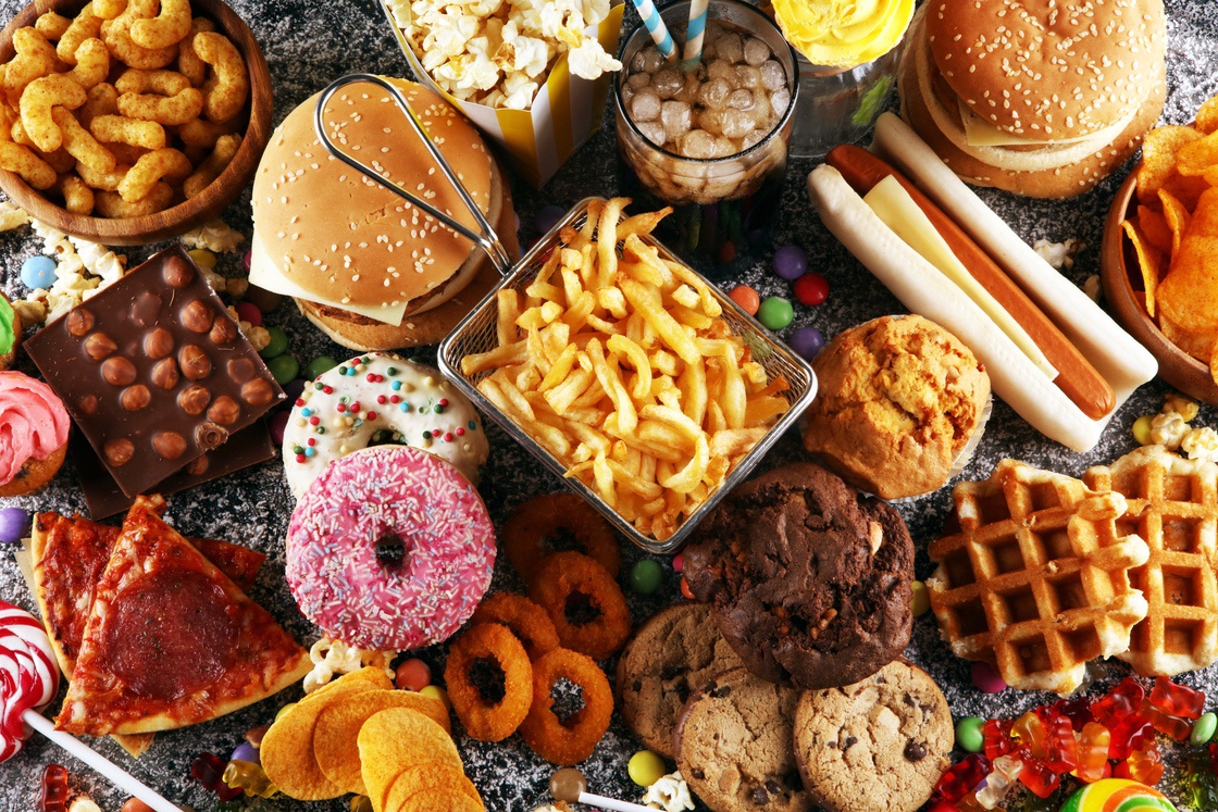 Unhealthy products. food bad for figure, skin, heart and teeth. Assortment of fast carbohydrates food with fries and cola